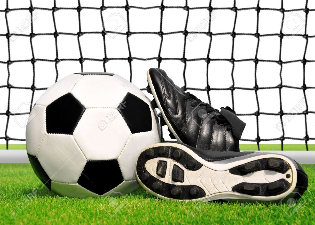 16225447 soccer ball and shoes in grass isolated